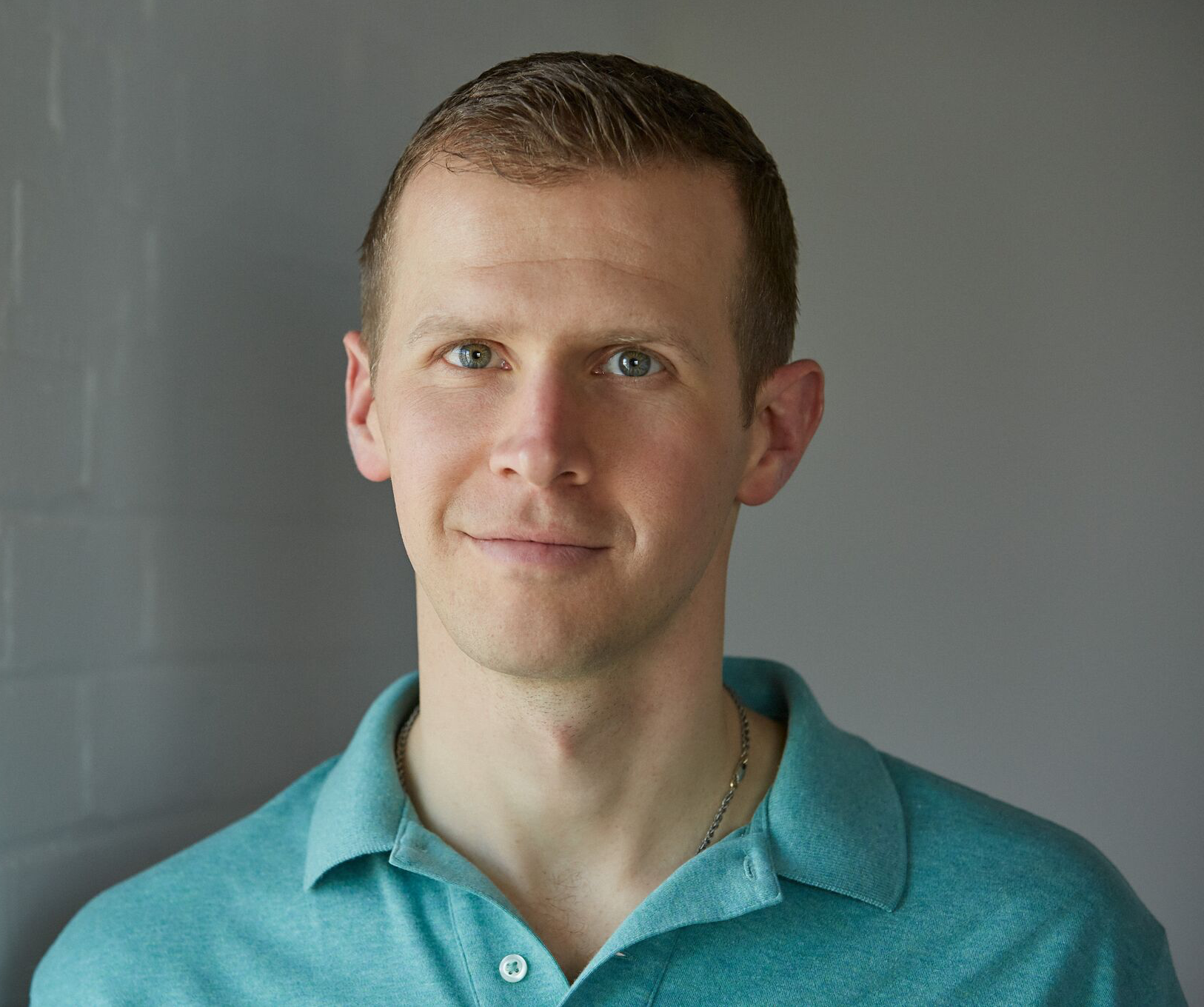 Ryan_Sternagel_Headshot_Green_Polo_White_Wall_Square.png